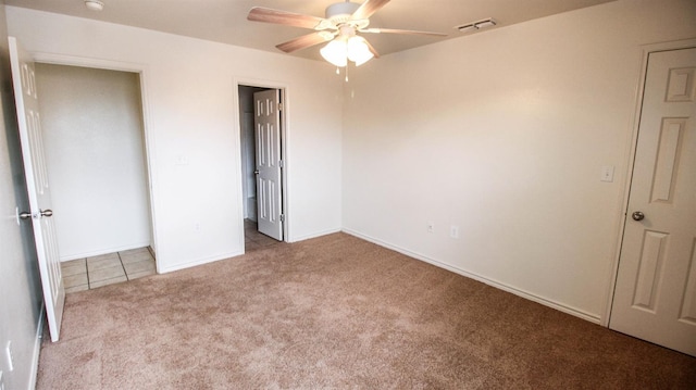 unfurnished bedroom with light carpet and ceiling fan