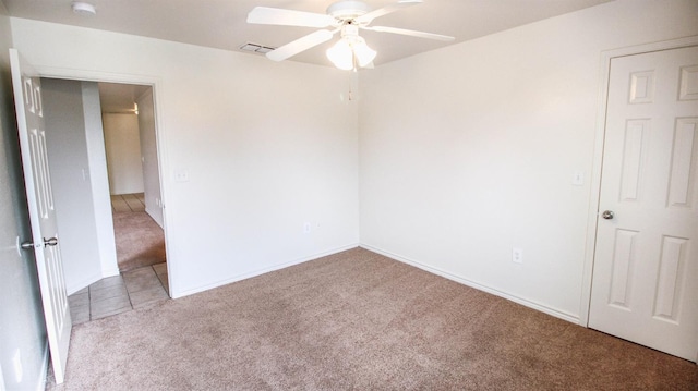 unfurnished room with light colored carpet and ceiling fan