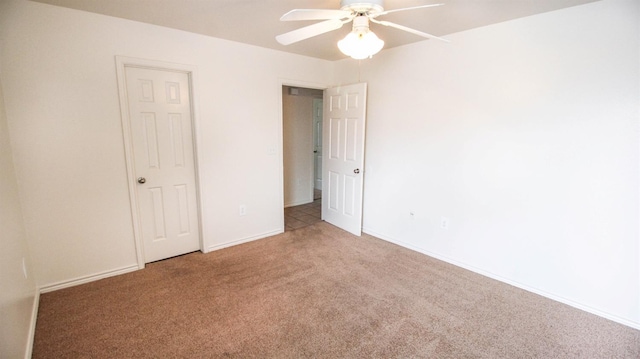 unfurnished bedroom featuring ceiling fan and carpet