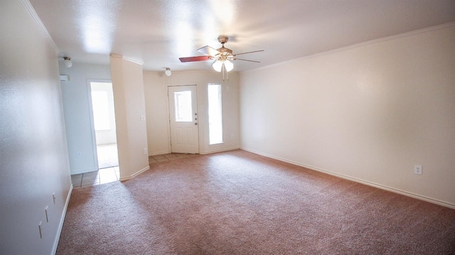 spare room featuring ornamental molding, carpet floors, and ceiling fan