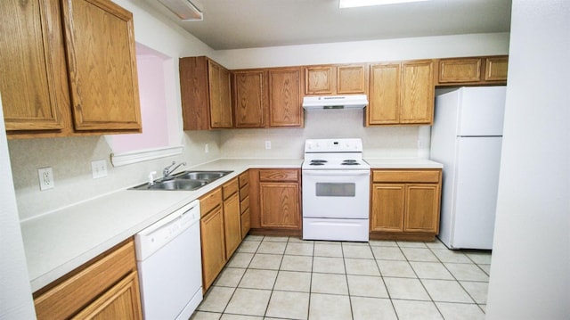 kitchen featuring light tile patterned flooring, white appliances, and sink