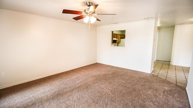 unfurnished room with crown molding, carpet floors, and ceiling fan