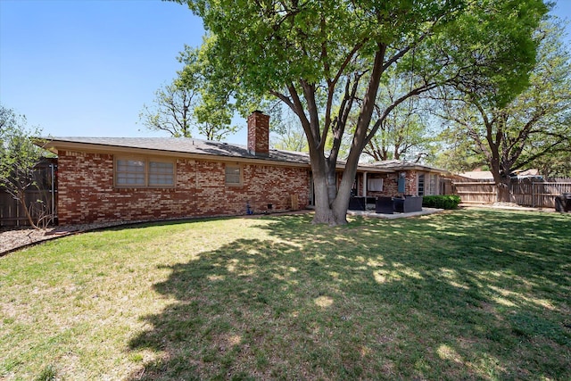 6201 Kenosha Dr, Lubbock, TX 79413 - back of house with a chimney, brick siding, and a patio area