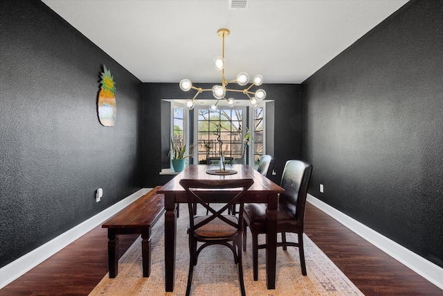 6201 Kenosha Dr, Lubbock, TX 79413 - dining area with a textured wall, wood finished floors, baseboards, and a chandelier