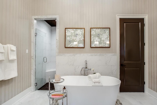 4821 119th Pl, Lubbock, TX 79424 - full bathroom featuring marble look tiles, a shower stall, a freestanding bath, and baseboards