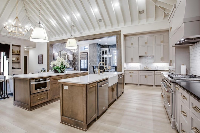 4821 119th Pl, Lubbock, TX 79424 - kitchen featuring custom range hood, an island with sink, a chandelier, stainless steel appliances, and a sink