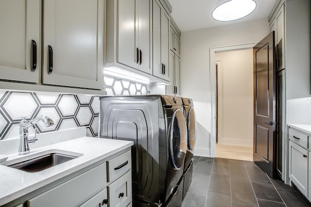 4821 119th Pl, Lubbock, TX 79424 - laundry room featuring cabinet space, washing machine and clothes dryer, baseboards, and dark tile patterned floors