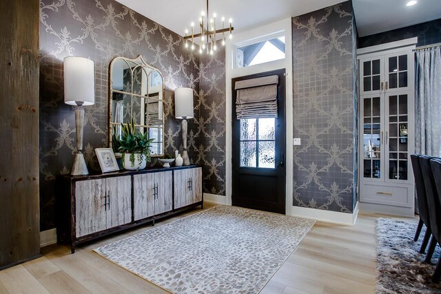 4821 119th Pl, Lubbock, TX 79424 - entryway featuring wallpapered walls, a chandelier, and wood finished floors