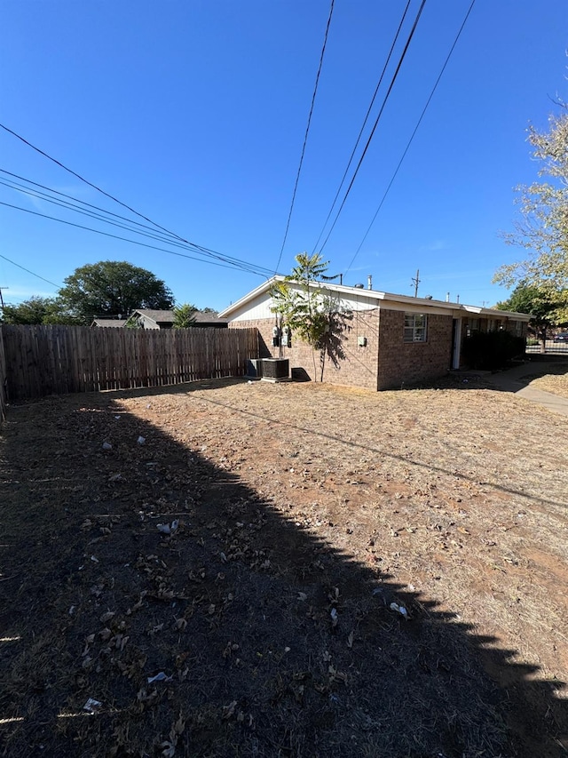 back of house with central AC