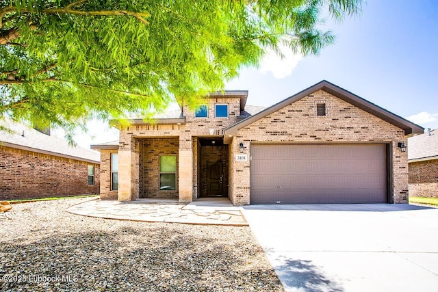 3404 Saratoga Ave, Lubbock, TX 79407 - view of front of home featuring brick siding, an attached garage, and concrete driveway