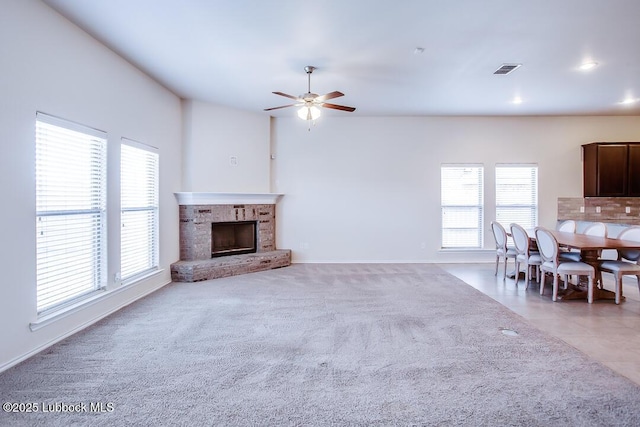 3404 Saratoga Ave, Lubbock, TX 79407 - unfurnished living room featuring healthy amount of natural light, ceiling fan, a fireplace, recessed lighting, and light colored carpet
