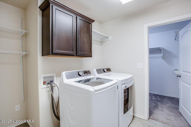 3404 Saratoga Ave, Lubbock, TX 79407 - washroom with cabinet space, washer and clothes dryer, light tile patterned flooring, and light carpet