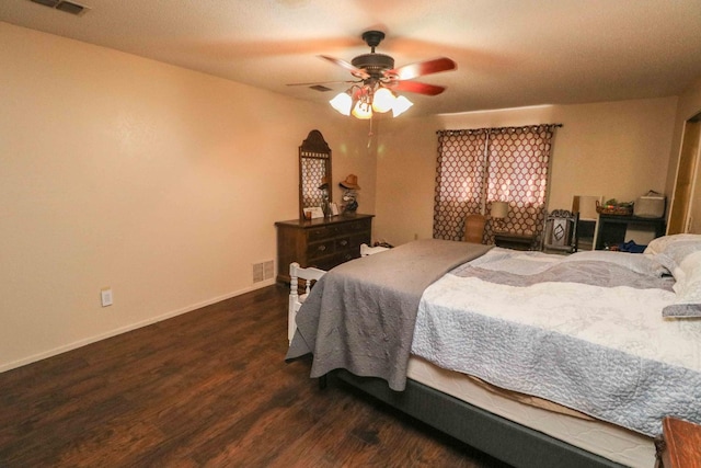 bedroom with dark hardwood / wood-style floors and ceiling fan