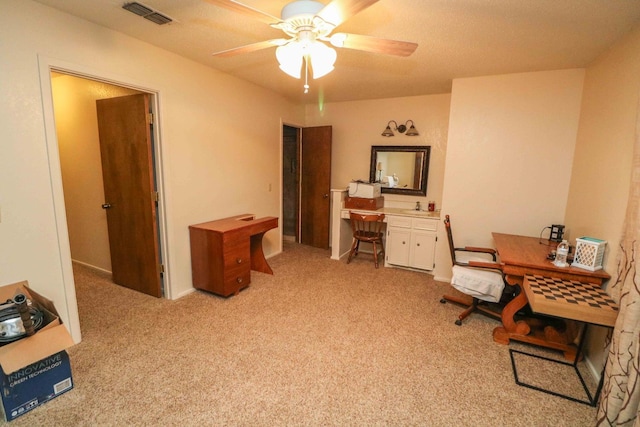 office with light colored carpet and ceiling fan