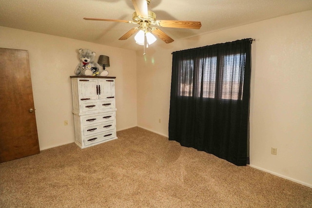 unfurnished bedroom with ceiling fan and carpet floors