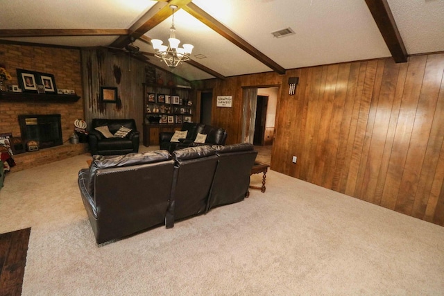 cinema room with wooden walls, vaulted ceiling with beams, carpet floors, a chandelier, and a brick fireplace