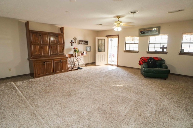 unfurnished room with ceiling fan and light colored carpet