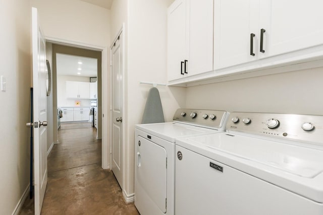 laundry room featuring cabinets and separate washer and dryer