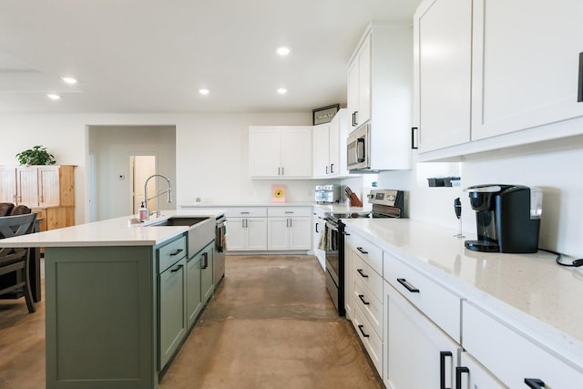 kitchen featuring sink, green cabinets, white cabinetry, stainless steel appliances, and a center island with sink