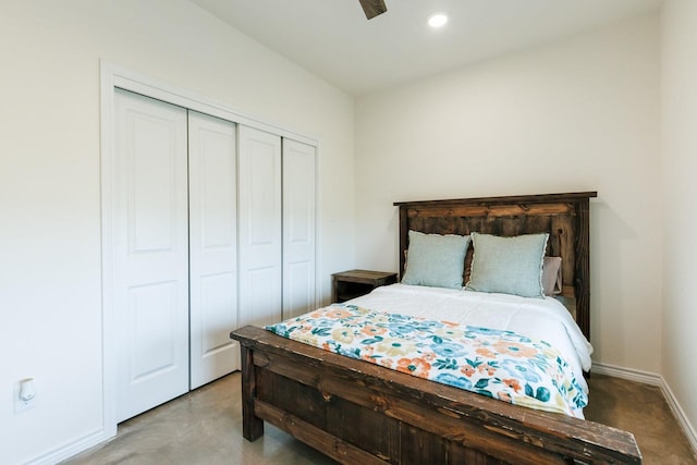 bedroom featuring concrete flooring and a closet