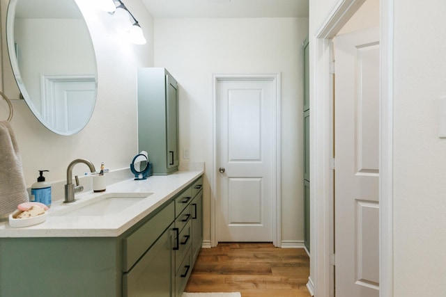 bathroom with hardwood / wood-style flooring and vanity