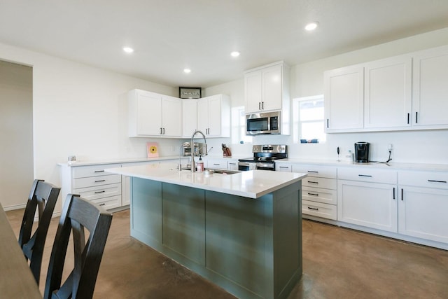 kitchen featuring white cabinetry, an island with sink, stainless steel appliances, and sink