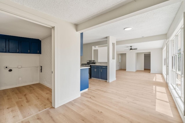 corridor with light hardwood / wood-style flooring and a textured ceiling