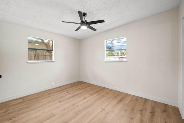 unfurnished room with ceiling fan, a textured ceiling, and light hardwood / wood-style floors