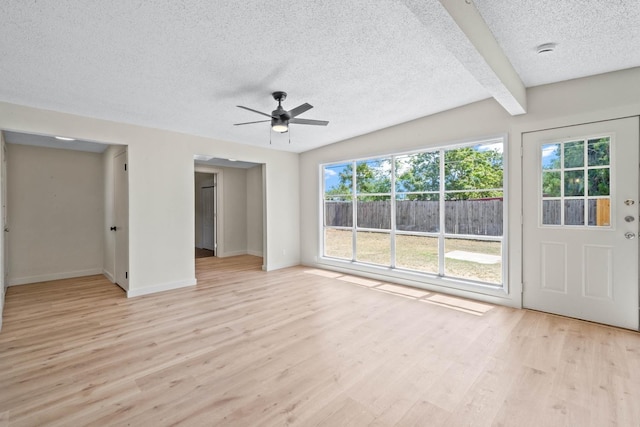 unfurnished bedroom with ceiling fan, a textured ceiling, and light hardwood / wood-style floors