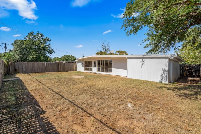 back of property featuring a lawn