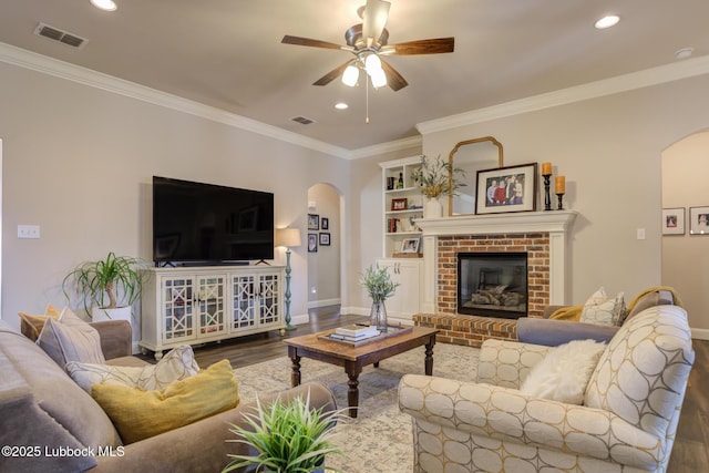 4008 124th St, Lubbock, TX 79423 - living area with arched walkways, wood finished floors, a ceiling fan, baseboards, and crown molding