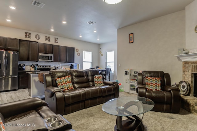 10423 Winfield Ave, Lubbock, TX 79424 - living area with light colored carpet, recessed lighting, and a fireplace