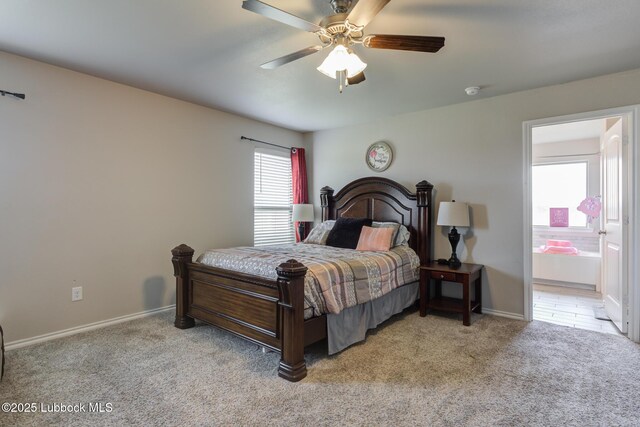 10423 Winfield Ave, Lubbock, TX 79424 - bedroom featuring light carpet, baseboards, connected bathroom, and ceiling fan