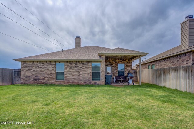 10423 Winfield Ave, Lubbock, TX 79424 - rear view of house with a patio, brick siding, a chimney, and roof with shingles
