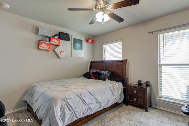 10423 Winfield Ave, Lubbock, TX 79424 - bedroom with light colored carpet, baseboards, and multiple windows