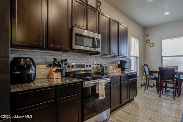 10423 Winfield Ave, Lubbock, TX 79424 - kitchen with stainless steel appliances, tasteful backsplash, dark stone counters, and recessed lighting