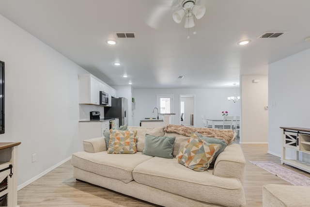 8413 10th Pl, Lubbock, TX 79416 - living area with light wood-style flooring, a ceiling fan, baseboards, and recessed lighting