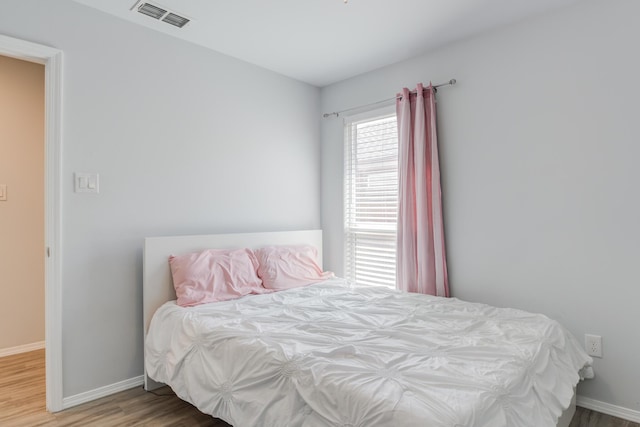 8413 10th Pl, Lubbock, TX 79416 - bedroom with wood finished floors and baseboards