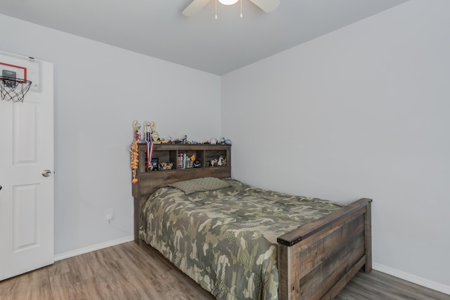 8413 10th Pl, Lubbock, TX 79416 - bedroom featuring wood finished floors, baseboards, and a ceiling fan