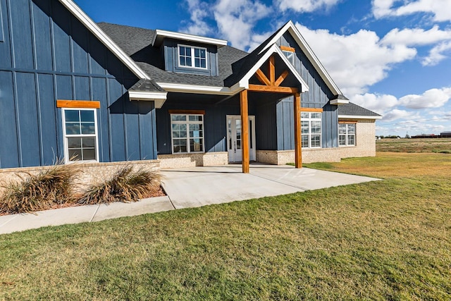 view of front of house with a patio area and a front yard