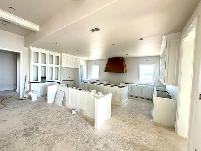 kitchen with plenty of natural light, white cabinets, and a kitchen island