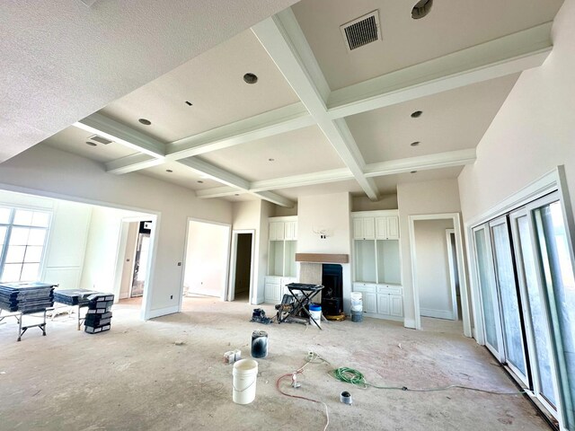 living room featuring coffered ceiling and beam ceiling