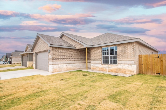 ranch-style home with a garage and a lawn