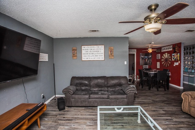 living room with hardwood / wood-style flooring and a textured ceiling