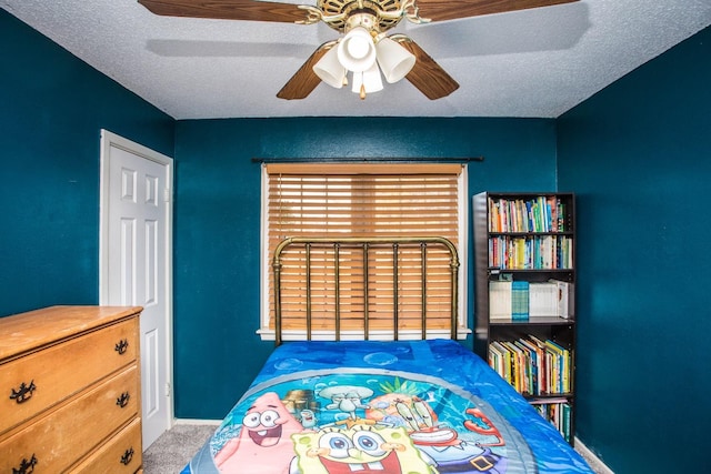 unfurnished bedroom with ceiling fan, carpet, and a textured ceiling