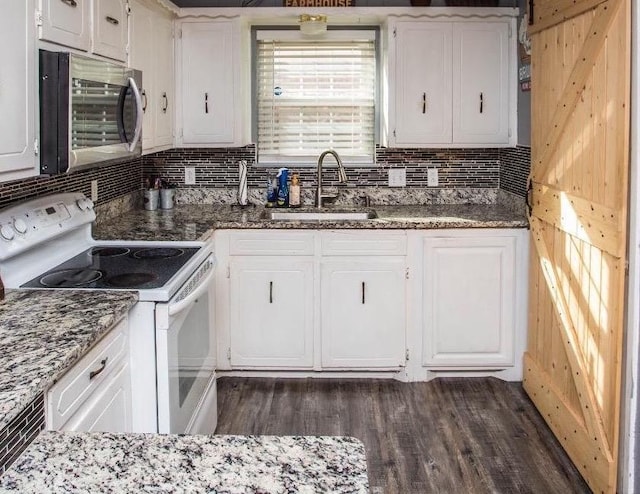 kitchen with dark wood-type flooring, sink, white cabinetry, tasteful backsplash, and white range with electric cooktop