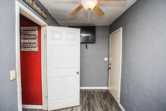 corridor featuring dark hardwood / wood-style flooring and a textured ceiling