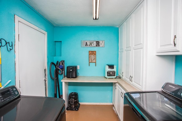 laundry room featuring independent washer and dryer and cabinets