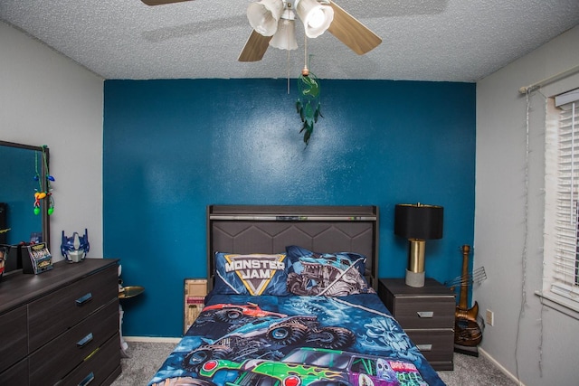 carpeted bedroom featuring ceiling fan and a textured ceiling