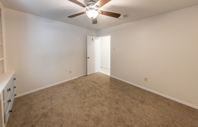 empty room featuring carpet and ceiling fan